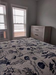 a bedroom with a bed and a dresser and window at Dupont Beach House B in Seaside Heights