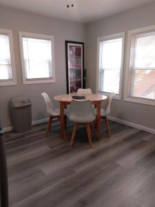 a dining room with a table and chairs and windows at Dupont Beach House B in Seaside Heights