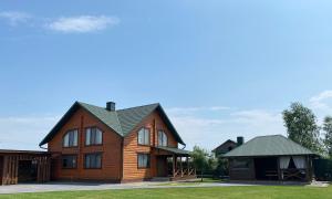 a large wooden house with a green roof at Pulmo rest house in Pulʼmo