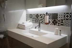 a bathroom with a white sink and a mirror at Campanile PRIME - Troyes Nord Barberey in Troyes +58 photos
