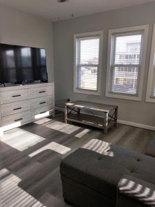 a living room with a flat screen tv and a couch at Dupont Beach House C in Seaside Heights