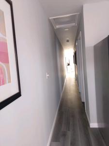 a hallway with white walls and a picture on the wall at Dupont Beach House C in Seaside Heights