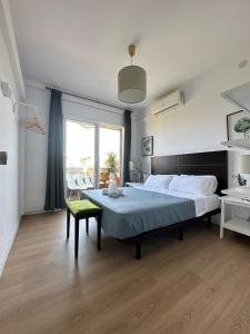 a bedroom with a large bed and a green chair at Plaza Spain Barcelona Apartments in Barcelona