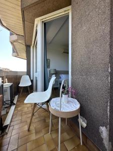 a room with a table and a chair on a balcony at Plaza Spain Barcelona Apartments in Barcelona