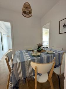 a dining room table with a blue and white striped table cloth at Plaza Spain Barcelona Apartments in Barcelona