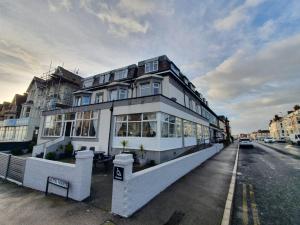a large white building on the side of a street at Brooklyn Hotel in Blackpool