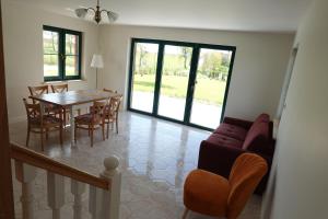 a living room with a dining room table and chairs at Ostoja Zielonki in Węgorzewo