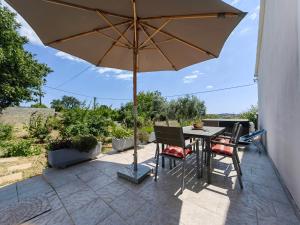 a table and chairs with an umbrella on a patio at Casa Istriana Pula in Pula