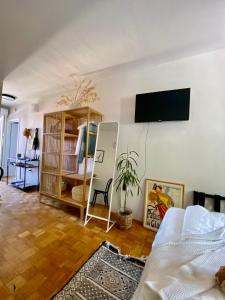 - un salon avec un lit et une télévision murale dans l'établissement Modern Couples Coastal Getaway MM, à Crikvenica