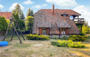 an old house with a tiled roof at Awesome Home In Lidzbark Warminski With House A Panoramic View in Lidzbark Warmiński