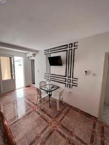 a dining room with a table and chairs and a television at Peci Apartments in Ulcinj