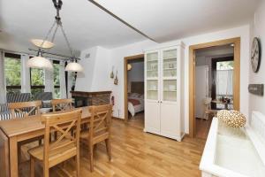 a dining room and living room with a table and chairs at Casa Eguzkilore by BeValle in Escarrilla