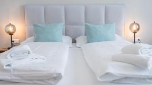 Marienhof Apartments tesisinde bir odada yatak veya yataklar