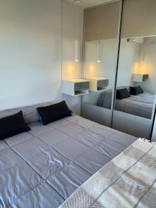 a bedroom with two beds and a mirror at Betania Plaza in Cordoba