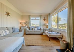 a living room with a bed and a couch at Eryl in Ferryside