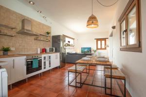 a kitchen with a table and a dining room at Villa Luz in Lajares