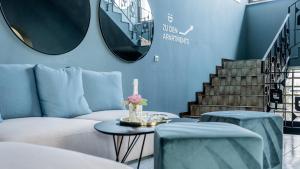 a living room with a couch and a table with a candle at Marienhof Apartments in Drobollach am Faakersee