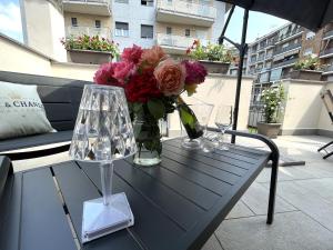 a table with a vase of flowers on a balcony at Only Time- Luxury Comfort House in Chivasso
