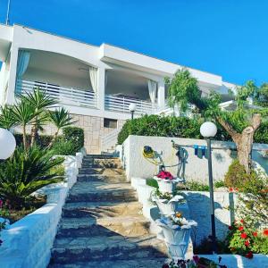 a house with a pathway in front of it at Villa Romana in Leporano Marina