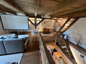 a living room with a couch and a large screen at Little Cottage No.100 in Vidochov
