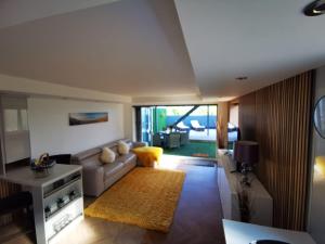 a living room with a couch and a table at Sister's Studio in Llanelli