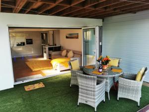 a patio with a table and chairs and a bedroom at Sister's Studio in Llanelli