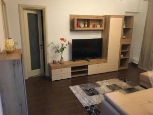 a living room with a flat screen tv on a entertainment center at Central Home in Piatra Neamţ