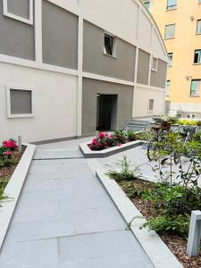 a walkway in front of a building with flowers at Studio 4 in Milan