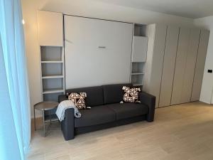 a living room with a black couch and a table at Studio 4 in Milan