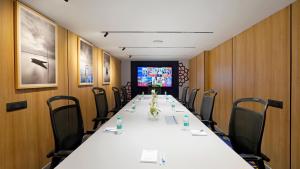 a conference room with a long table and chairs at Aiden by Best Western Hennur in Bangalore