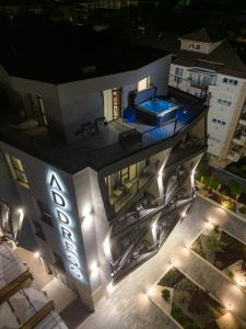 an aerial view of a building at night with a swimming pool at хотел ADDRESS in Ravda