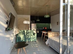 a bedroom with a bed and a table and a kitchen at Primavera Suites in Buenos Aires