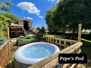 un bain à remous dans un jardin avec une clôture dans l'établissement Pod - Sleeps 2 - Jacuzzi - Parking - Garden, à Colombiers-du-Plessis