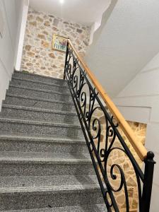 a staircase in a house with a stone wall at Stonevilla Buta in Himare