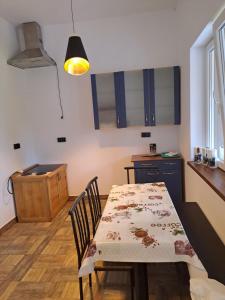 a kitchen and dining room with a table and chairs at Noclegi u Wandy in Ropienka