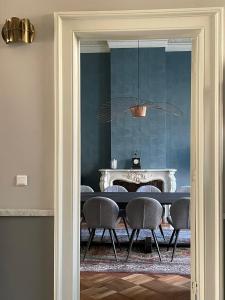a dining room with a table and chairs at Bed & Breakfast By Genck in Oudenbosch
