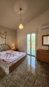 a bedroom with a bed and a large window at Sea's Chalet in Fontane Bianche +51 photos