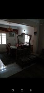 a living room with a couch and a table at Gibran residence in Kafr al Ishārah