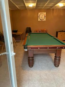 a pool table sitting inside of a room with at Adam Apartman in Hajdúszoboszló