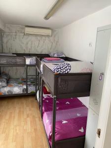 a small room with three bunk beds in it at Hostal Madrid Paradise in Madrid