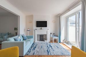 a living room with a couch and a fireplace at Wave Cottage by Bloom Stays in Sandgate