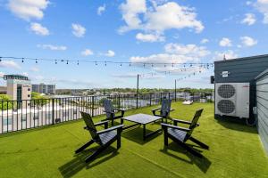 a patio with a table and chairs on a balcony at 10 Ocean A Powered By Atkinson Realty in Virginia Beach