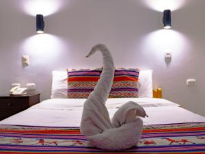 Cama ou camas em um quarto em Hotel Santa Maria