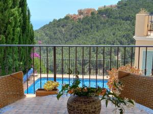 a balcony with a view of a swimming pool at Villa Suiza in Altea