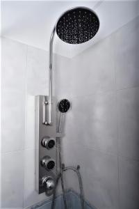 a shower with a shower head in a bathroom at Pasas Castle - Unique Luxury Apartments in Naxos Chora