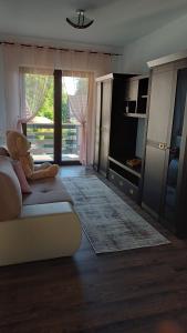 a living room with a teddy bear sitting on a couch at Dragomirna Sunset in Mitocu Dragomirnei