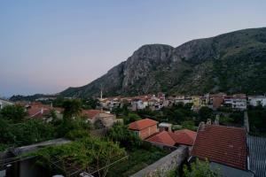 een stad tegenover een berg met huizen bij Liman Rooms and Apartments in Mostar