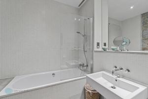 a bathroom with a tub and a sink and a shower at 3 Bed Edenhurst By Pureserviced in Plymouth