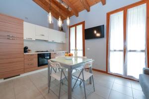 eine Küche mit einem Tisch und Stühlen im Zimmer in der Unterkunft Apartment baglio degli ulivi in Sirmione