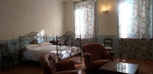 1 dormitorio con 1 cama, 2 sillas y mesa en Villa Amai, en Lequio Tanaro